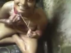 In an outdoor shower, a plump Indian floozy is washing her body.
